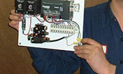 <John Uske with a liquid level controller he made>